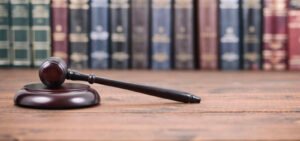 Peter Wachowski Criminal Defense Lawsuits image. Photo of a gavel sitting in front of legal texts.